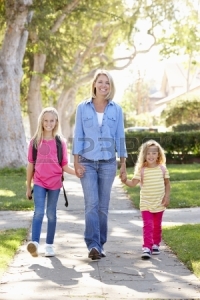 19531317-mother-and-daughters--on-city-street